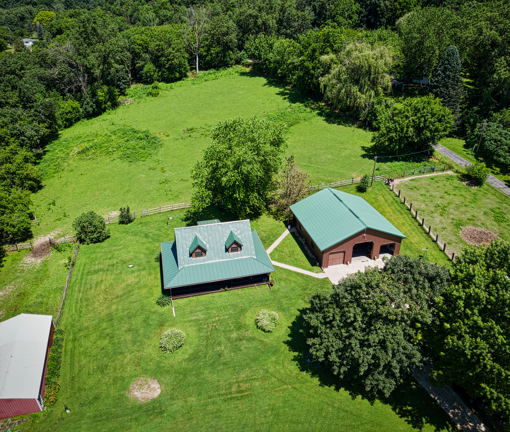 Aerial Photo of House Surrounded by Luscious Land